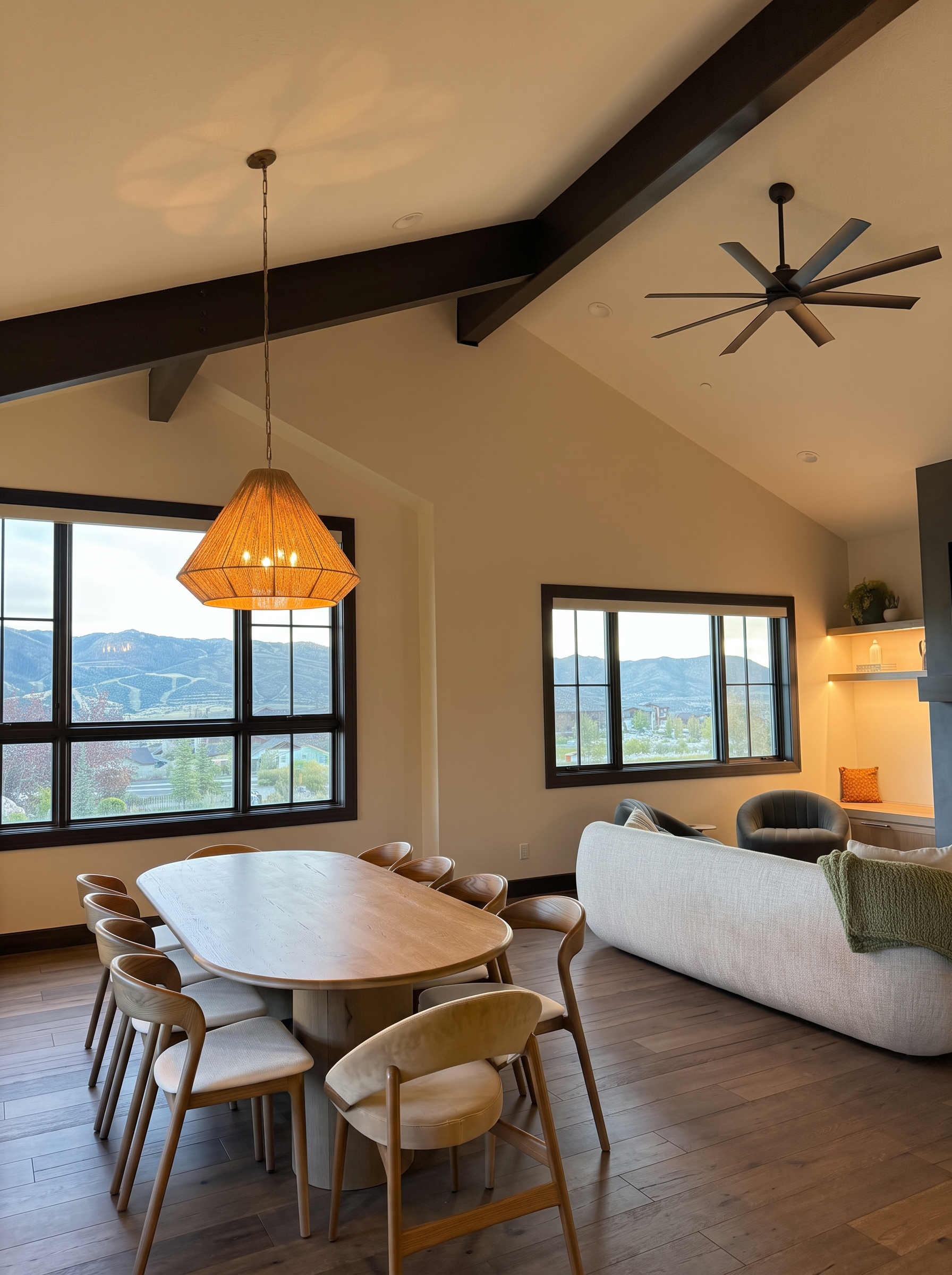 Dining table at sunset with black-framed windows framing the Deer Valley East ski runs