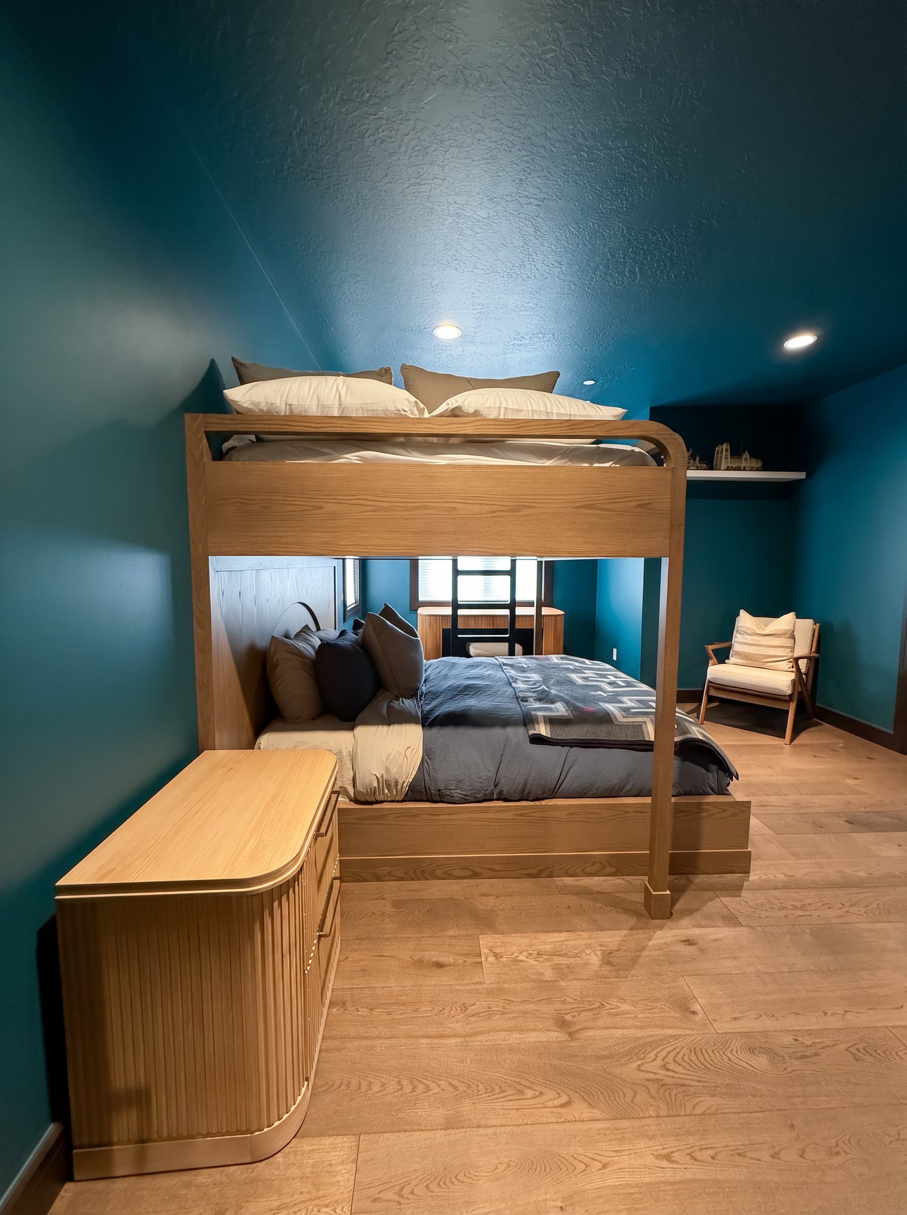 Second view of the oak queen-over-queen bunk bed with oak dresser and lounge chair