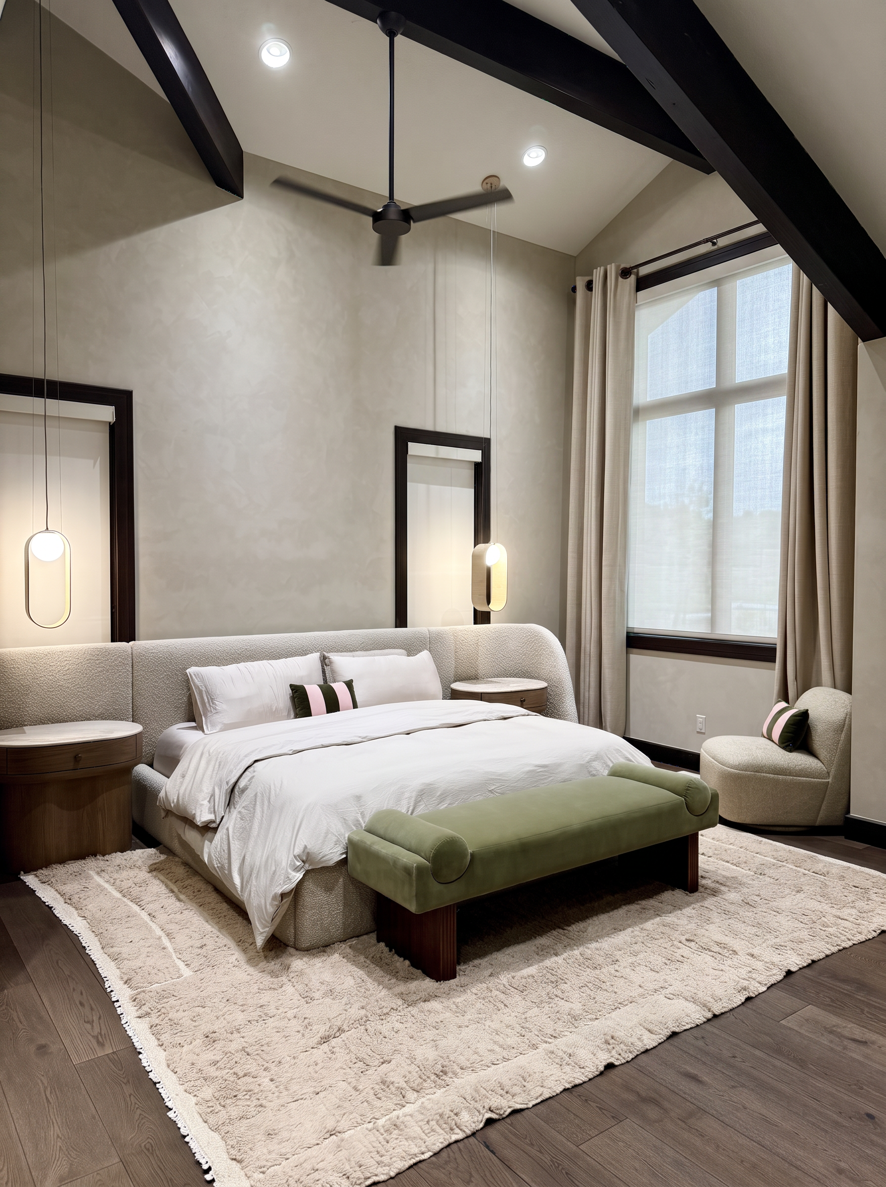 Primary suite under vaulted beamed ceilings with boucle bed, pendant lights, and a velvet bench
