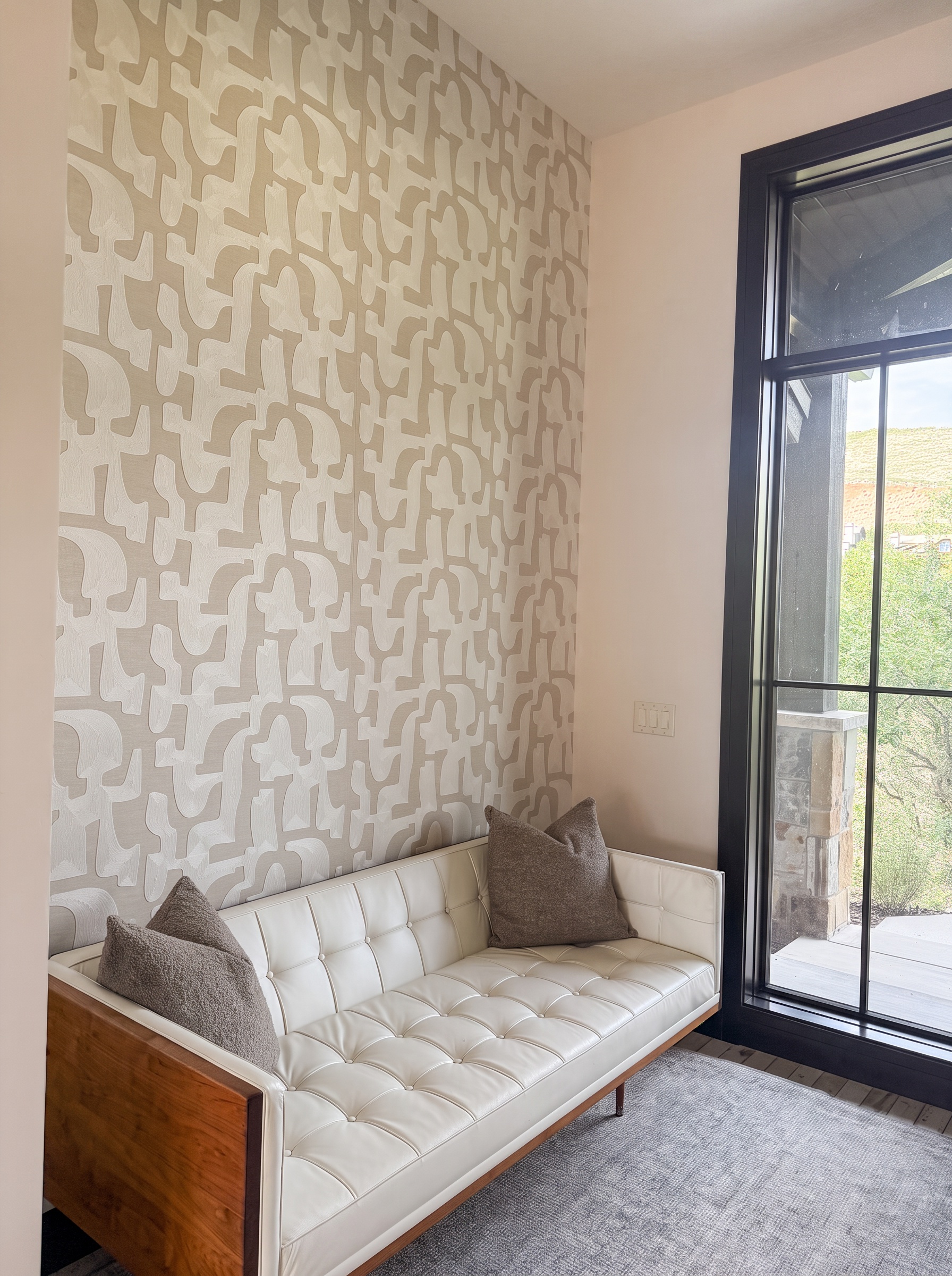 Kay Haus entryway window seat with garden light and patterned wallpaper