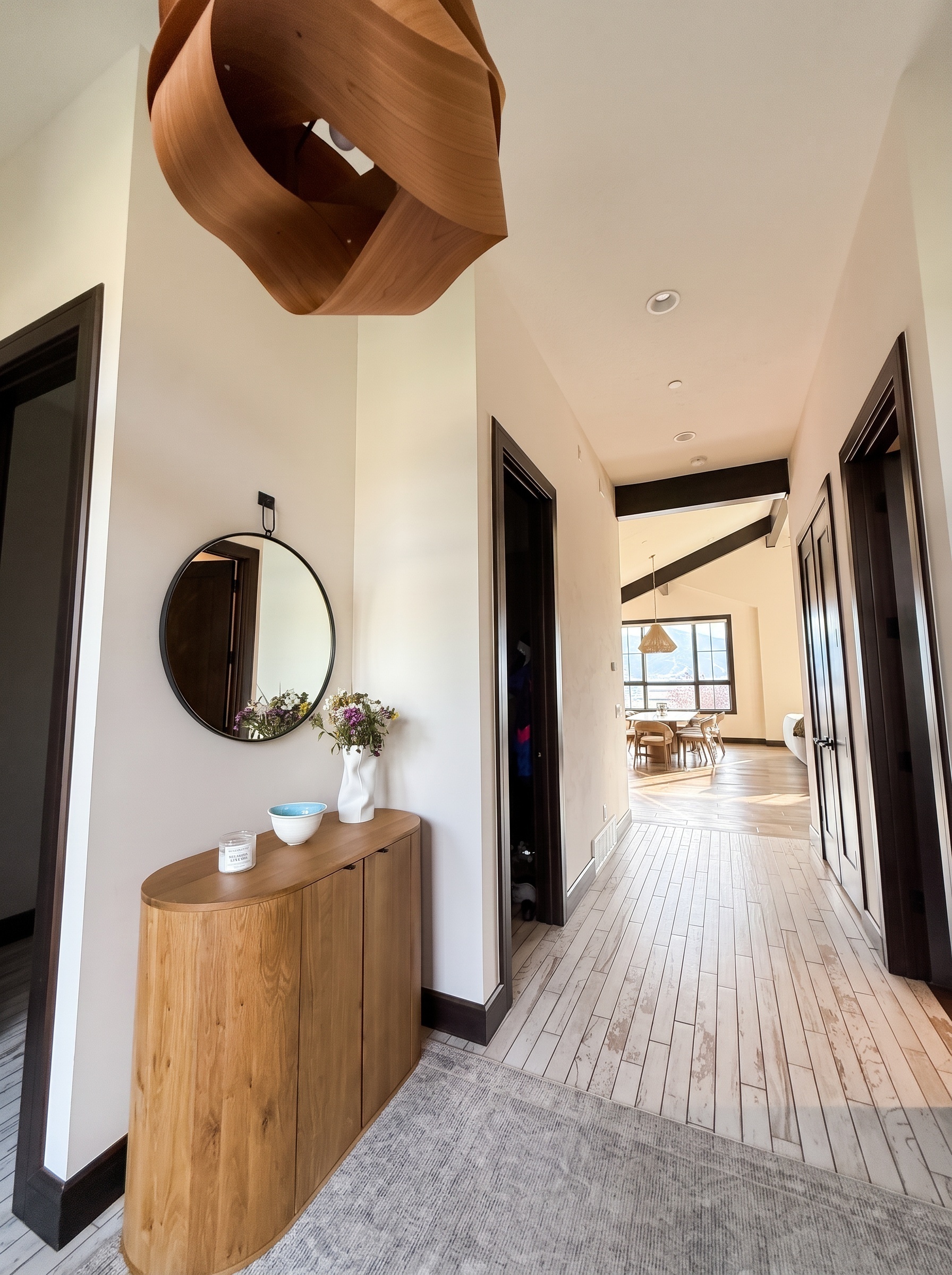 Long hallway view from the entry toward the dining area and mountain windows